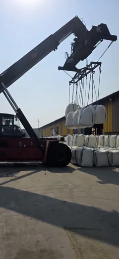 Material handler lifting several jumbo bags